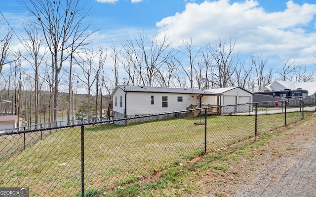 manufactured / mobile home featuring metal roof, fence, and a front lawn