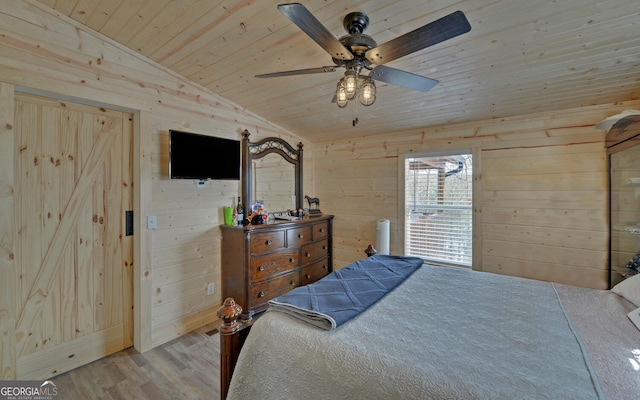 bedroom featuring vaulted ceiling, wooden ceiling, wood finished floors, and wooden walls