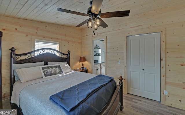 bedroom with wood ceiling, ceiling fan, wooden walls, and wood finished floors