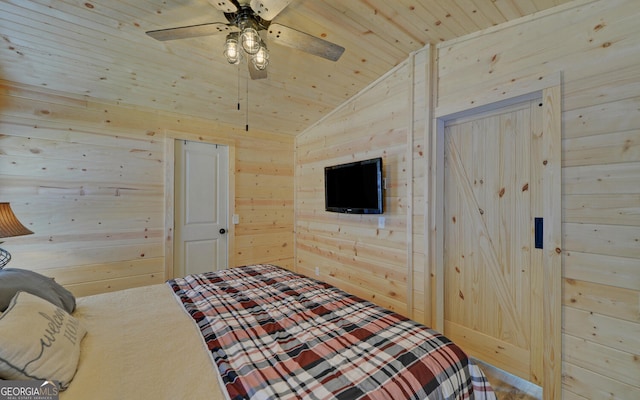 bedroom with lofted ceiling, ceiling fan, wood walls, and wooden ceiling