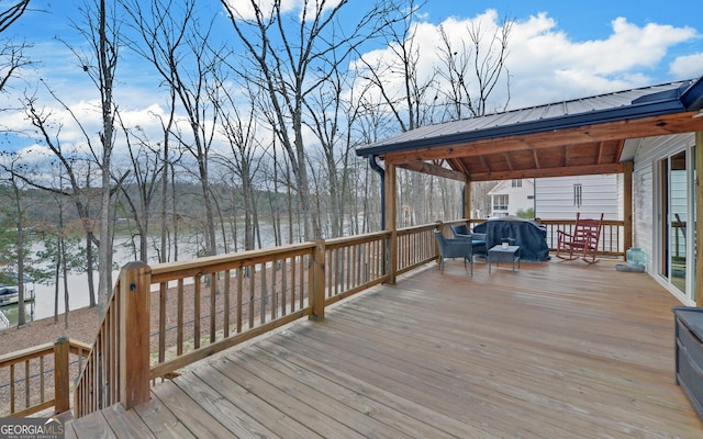 wooden terrace with a grill