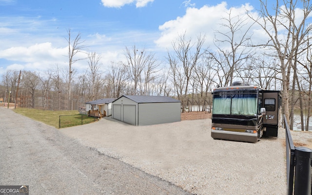 exterior space with a garage and an outbuilding