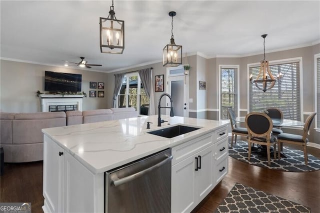 kitchen with dark wood-style flooring, a sink, stainless steel dishwasher, a wealth of natural light, and crown molding