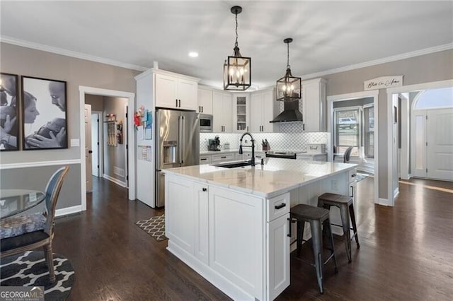 kitchen with tasteful backsplash, glass insert cabinets, appliances with stainless steel finishes, white cabinetry, and a sink