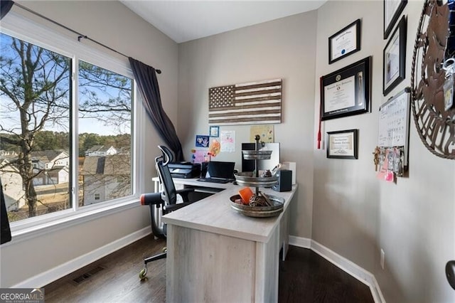 home office featuring visible vents, dark wood finished floors, and baseboards