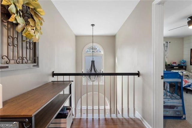 hallway featuring an inviting chandelier