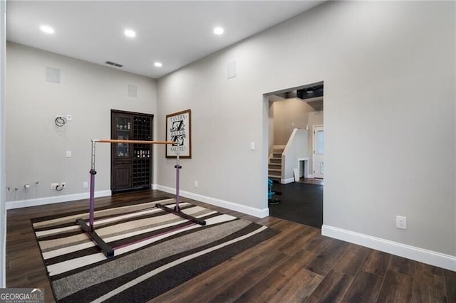 interior space with baseboards, stairway, wood finished floors, and recessed lighting