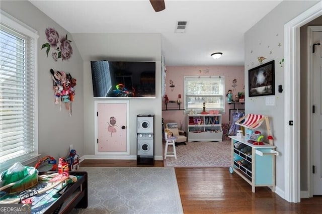 rec room with visible vents, ceiling fan, baseboards, and wood finished floors