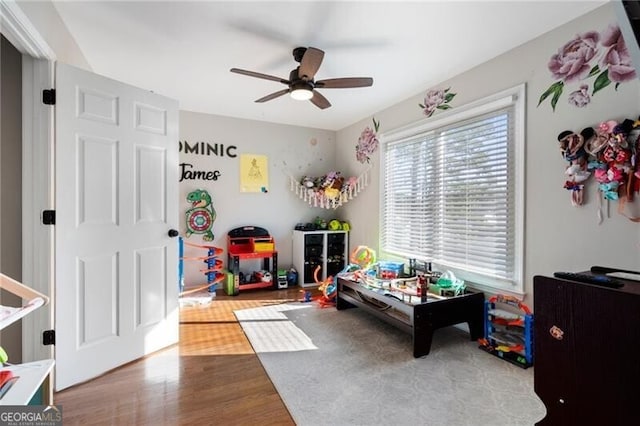 game room with ceiling fan and wood finished floors