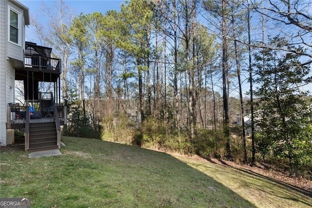 view of yard featuring a deck and stairway