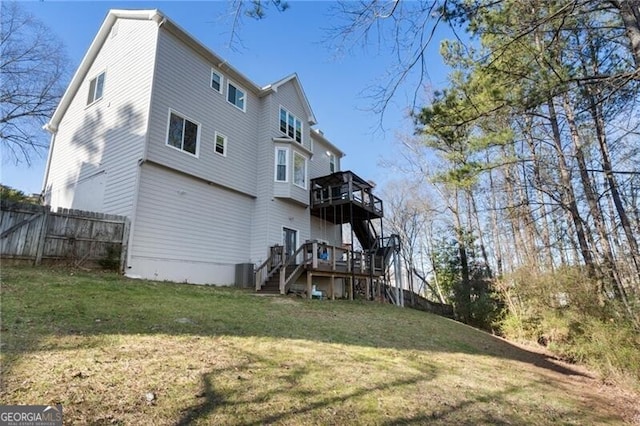 back of property with stairway, fence, a deck, a yard, and central air condition unit