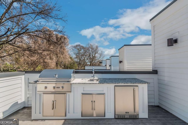 view of patio / terrace featuring a grill, an outdoor kitchen, and a sink