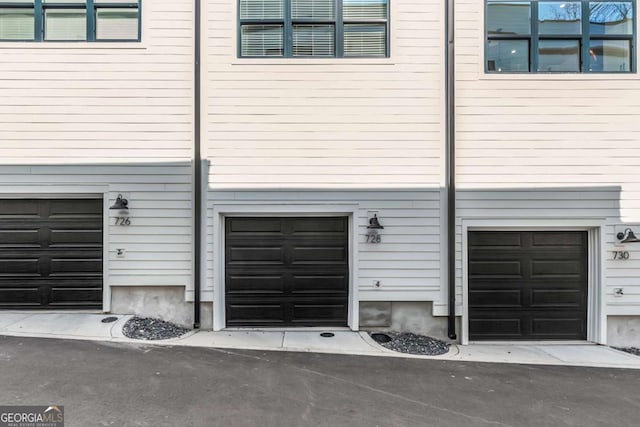 garage with aphalt driveway