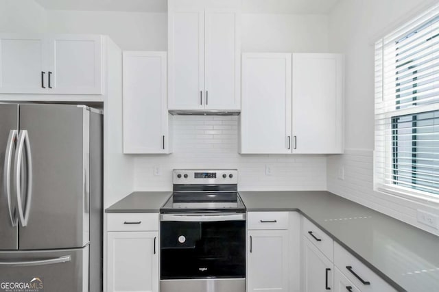 kitchen featuring stainless steel appliances, white cabinets, and decorative backsplash