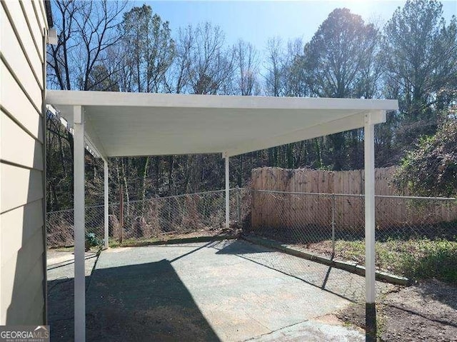 view of patio / terrace featuring a carport and fence