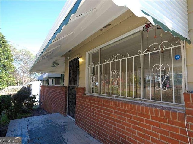 view of side of property featuring brick siding