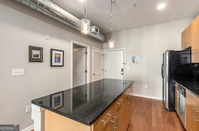 kitchen with brown cabinetry, dark wood-style flooring, a center island, hanging light fixtures, and stainless steel dishwasher