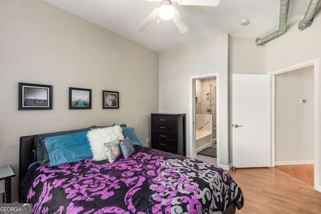 bedroom featuring ensuite bath, a ceiling fan, and wood finished floors