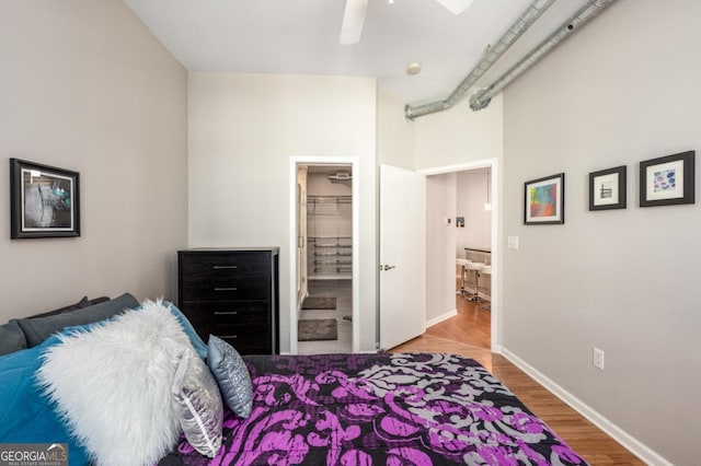 bedroom featuring ceiling fan, wood finished floors, and baseboards