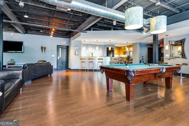 recreation room featuring a dry bar, a high ceiling, wood finished floors, and pool table