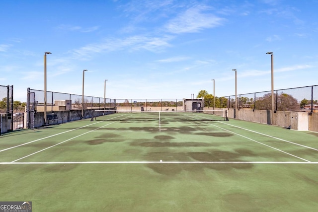 view of sport court featuring fence