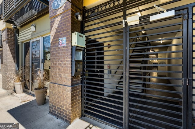 view of exterior entry with brick siding