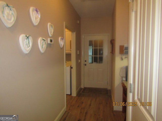 corridor featuring baseboards and wood finished floors