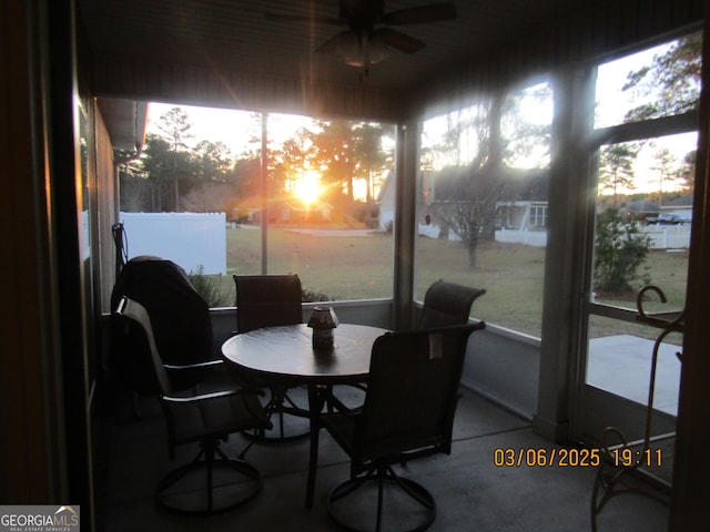 sunroom / solarium with a healthy amount of sunlight and a ceiling fan