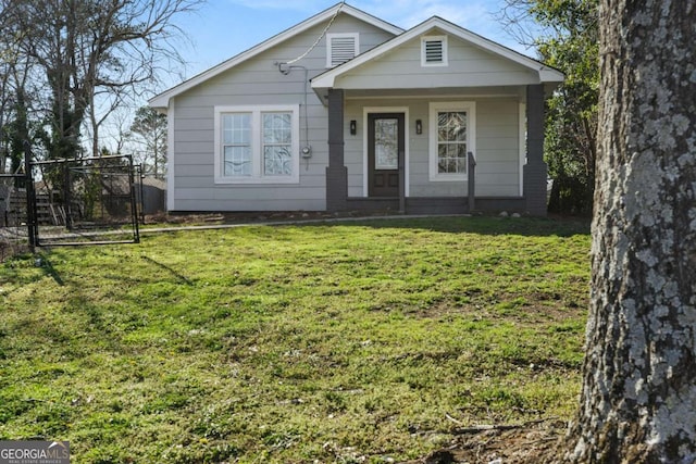 bungalow-style house featuring a front yard, a gate, and fence