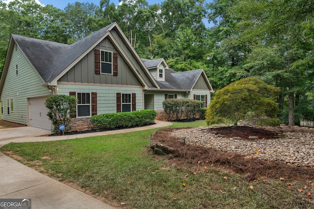 craftsman-style home with driveway, a front lawn, board and batten siding, and a shingled roof