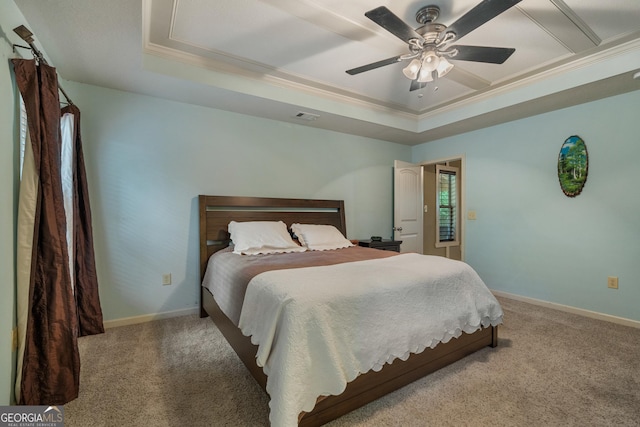 bedroom with visible vents, a tray ceiling, and carpet flooring