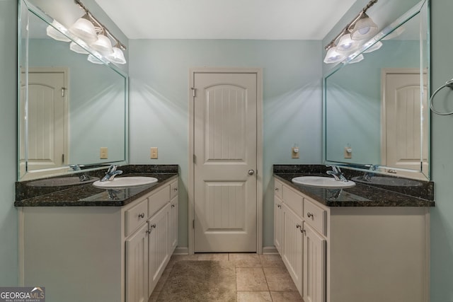 bathroom featuring two vanities and a sink