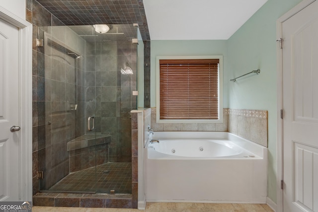 full bathroom featuring a whirlpool tub and a shower stall