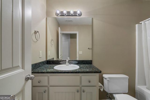 bathroom featuring visible vents, vanity, and toilet