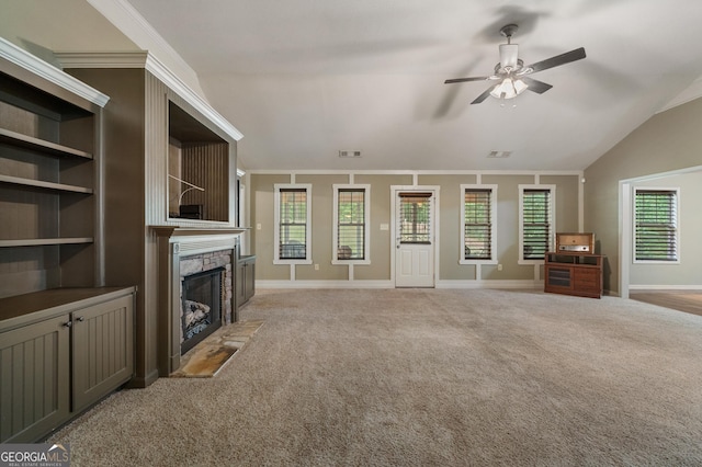 unfurnished living room with lofted ceiling, ceiling fan, light colored carpet, a fireplace with flush hearth, and baseboards