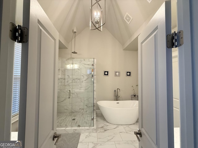 full bathroom with marble finish floor, a marble finish shower, visible vents, vaulted ceiling, and a freestanding bath
