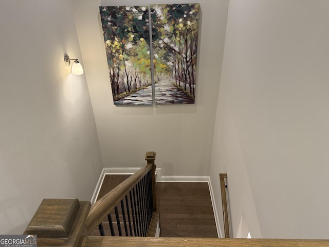 stairway featuring wood finished floors and baseboards