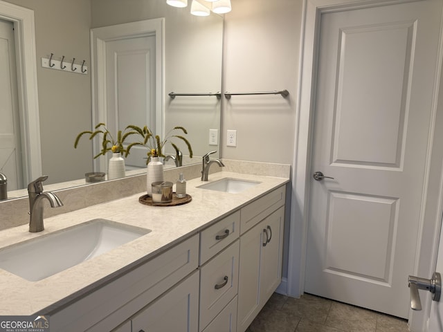 bathroom with double vanity, tile patterned flooring, and a sink