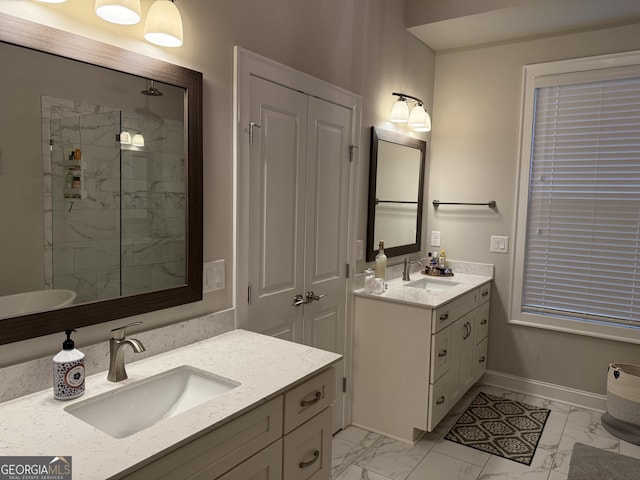 bathroom featuring a marble finish shower, marble finish floor, two vanities, and a sink