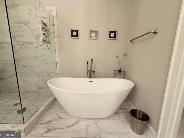 full bath featuring a marble finish shower, baseboards, marble finish floor, and a freestanding tub