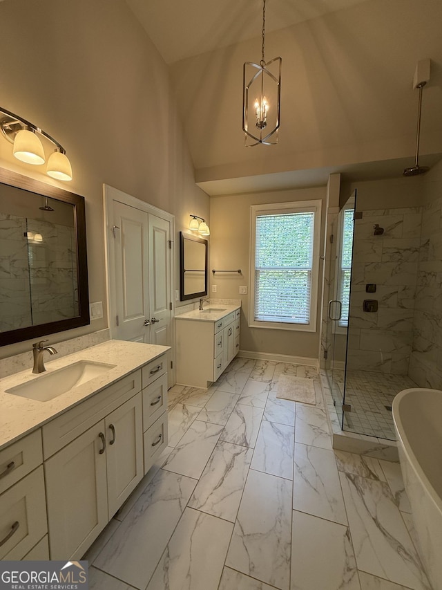 bathroom featuring a stall shower, a sink, two vanities, a notable chandelier, and marble finish floor