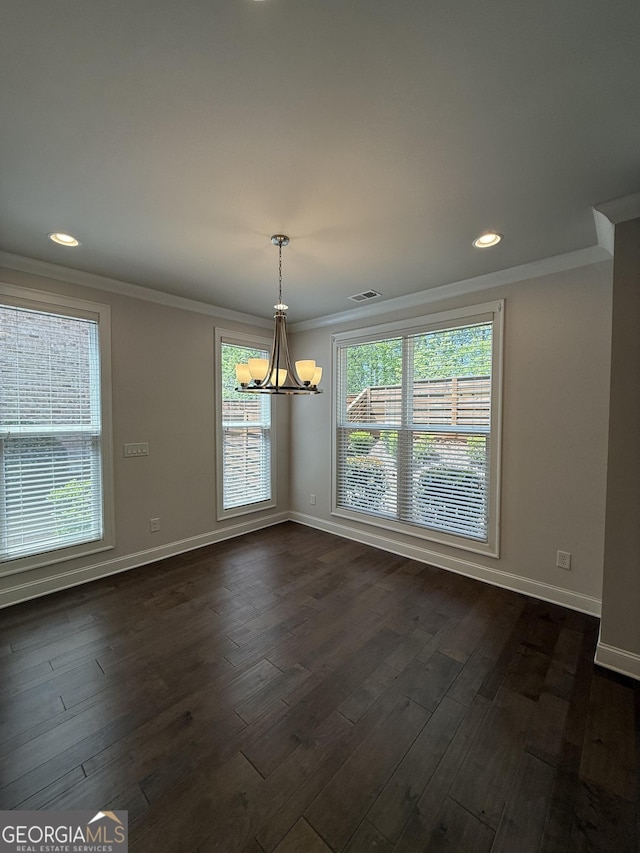 unfurnished dining area featuring an inviting chandelier, crown molding, visible vents, baseboards, and dark wood-type flooring
