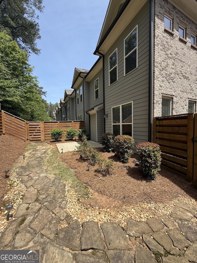 view of home's exterior featuring a gate and fence