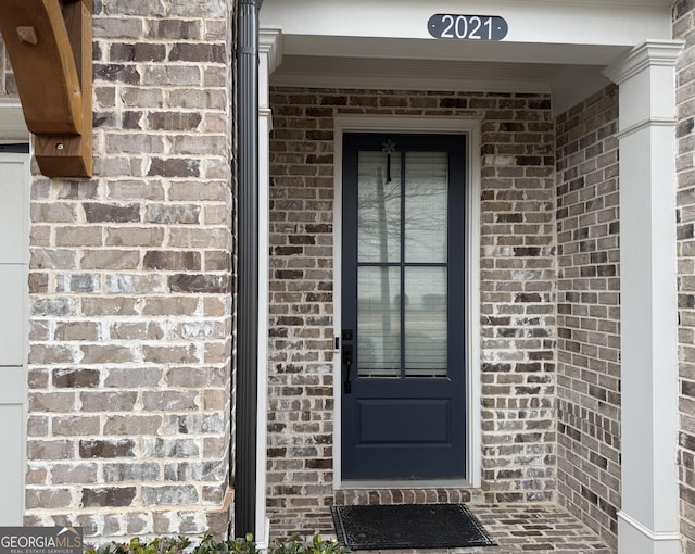 property entrance with brick siding