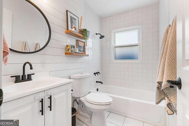 bathroom featuring toilet, tile patterned floors, shower / bath combination, and vanity