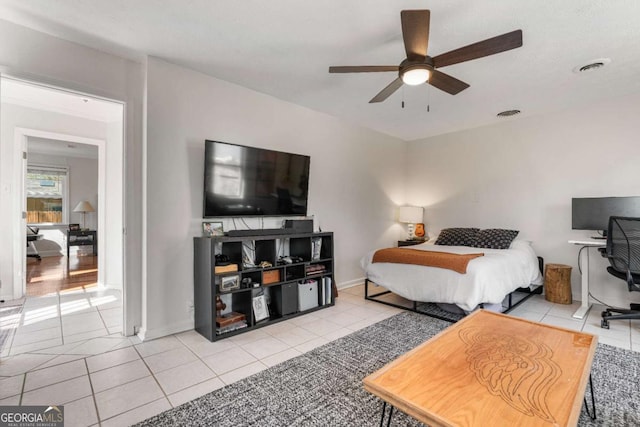 bedroom featuring ceiling fan, visible vents, and light tile patterned flooring