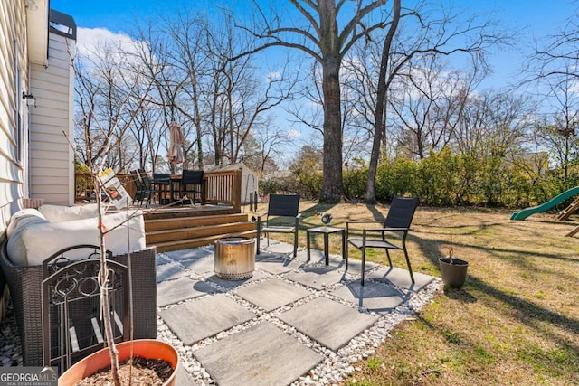 view of patio / terrace with a playground and a deck