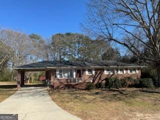 ranch-style house with an attached carport and concrete driveway