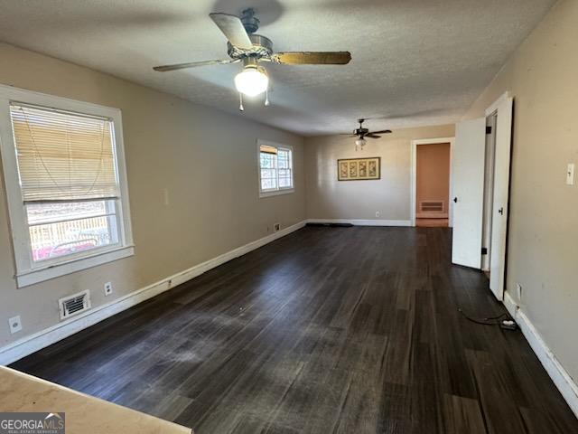 interior space featuring visible vents, baseboards, and wood finished floors