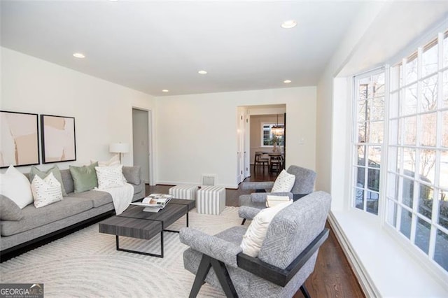 living room featuring baseboards, wood finished floors, visible vents, and recessed lighting